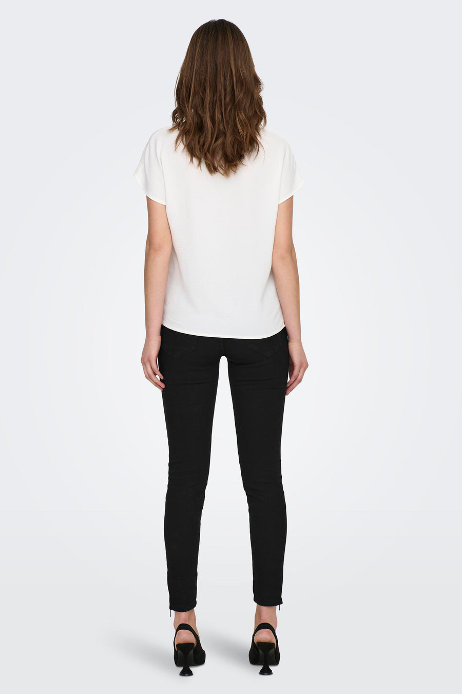Wit blouse met korte mouwen van JDY, gedragen met een zwarte broek en hoge hakken.
