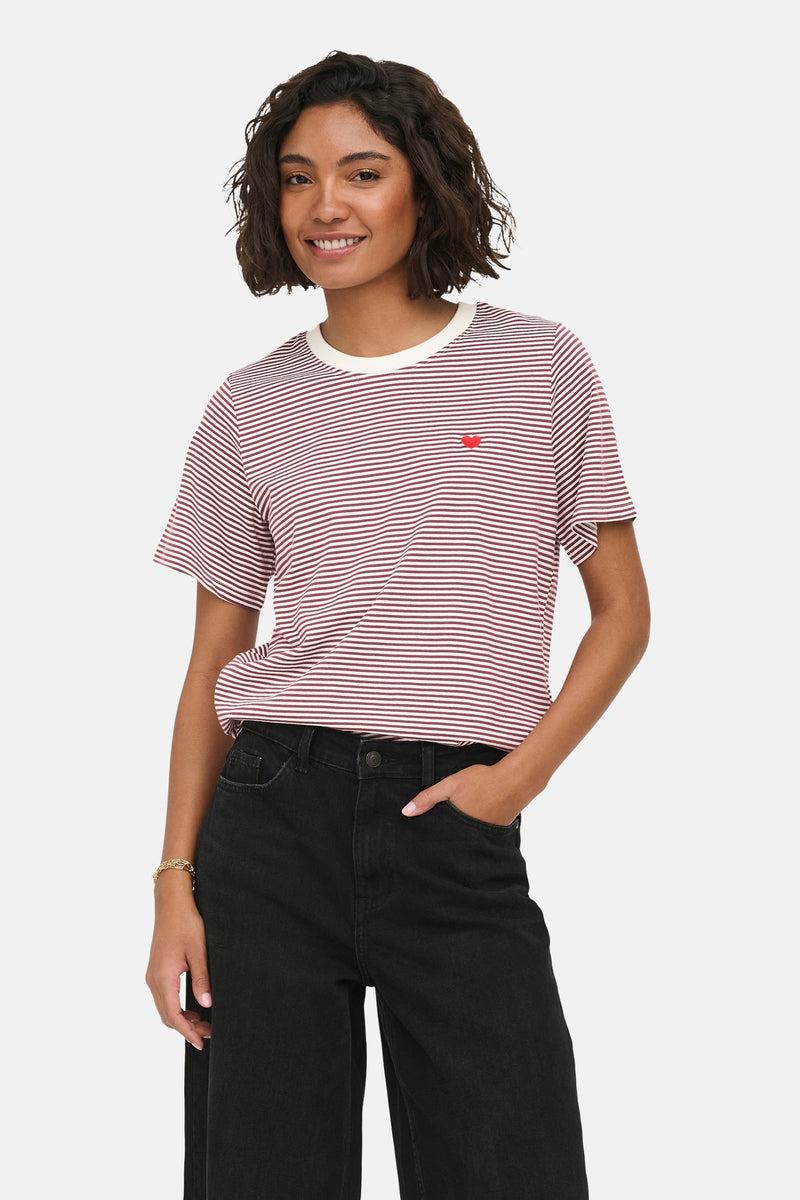 Red and white striped short-sleeve t-shirt with small red heart patch, worn by model with black jeans, front view