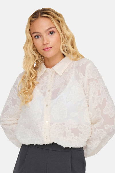 Chemisier blanc à manches longues de JDY, orné d'un motif texturé floral en transparence.