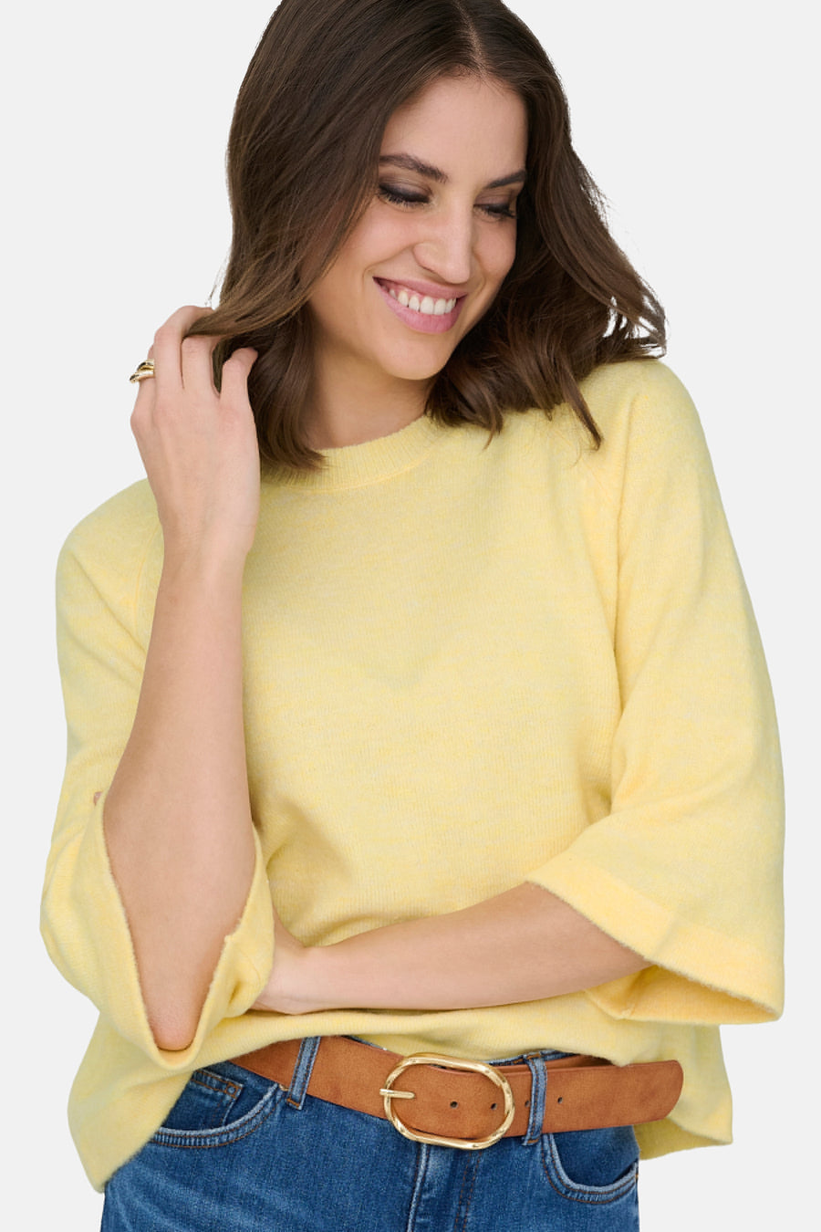 Pull jaune à col rond de ONLY, porté avec une ceinture marron et un jean bleu.
