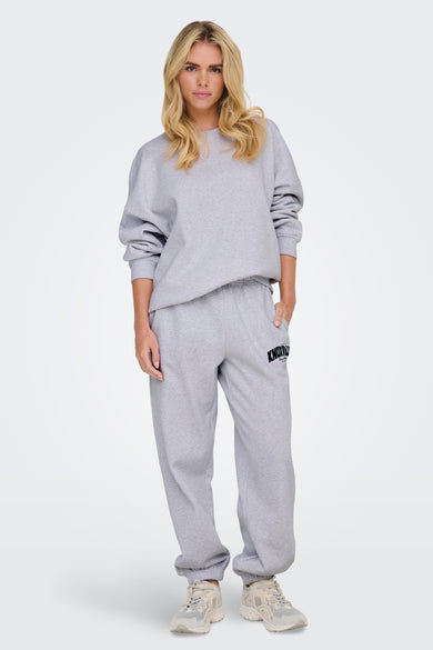 Sweat col rond gris par ONLY®, porté par une femme, avec des manches longues et un ourlet droit.