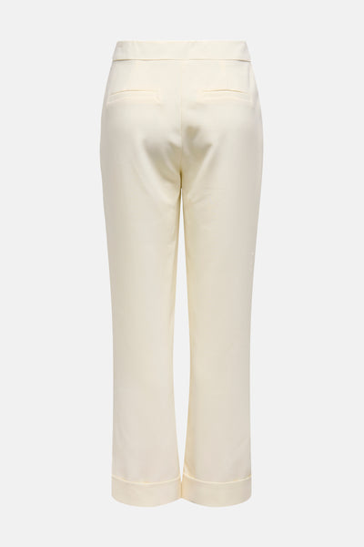 Pantalon écru by ONLY, avec poches arrière passepoilées et ourlets larges.