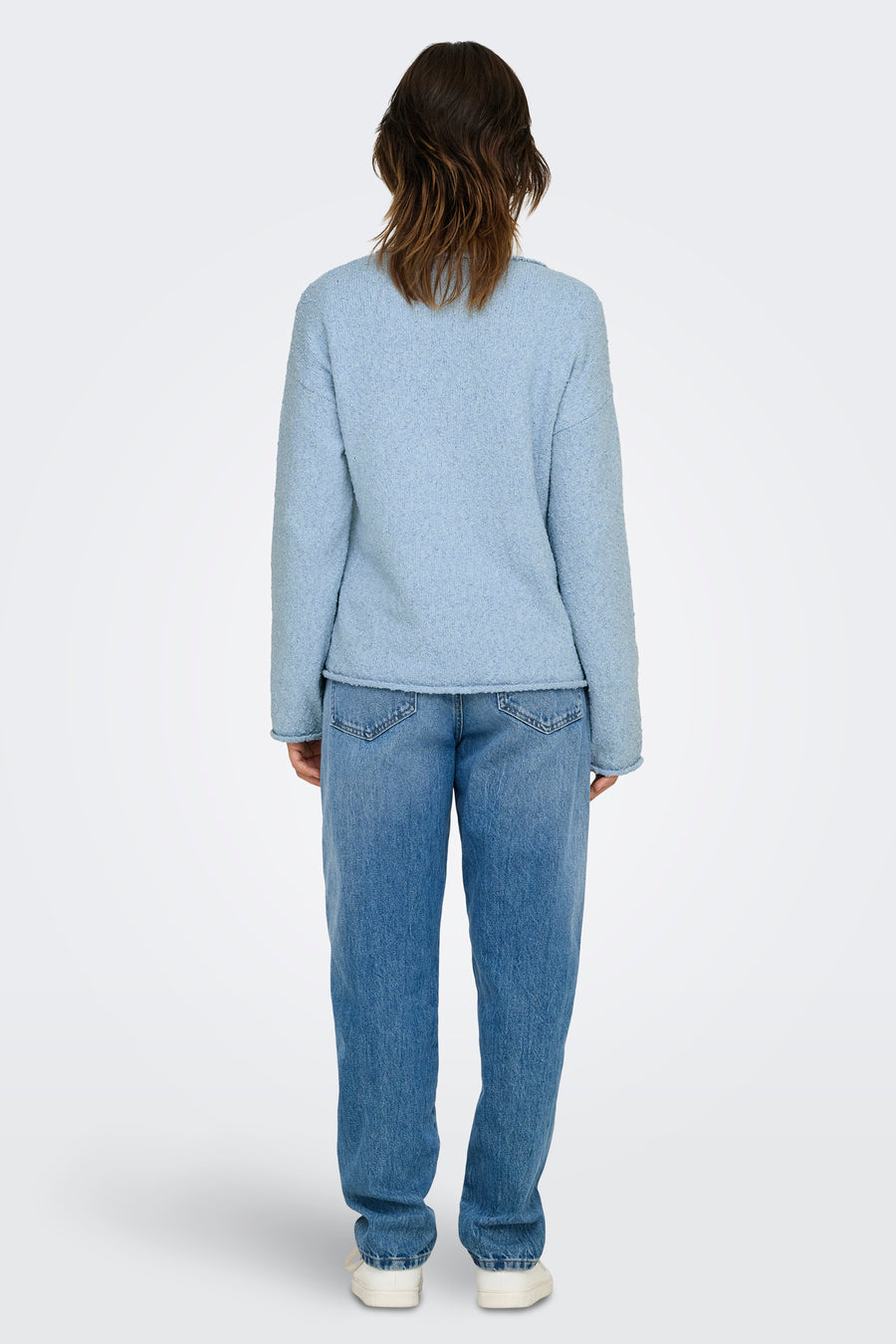 Ronde hals trui blauw van ONLY, gedragen met een hoge taille spijkerbroek blauw en witte schoenen, achterzicht.