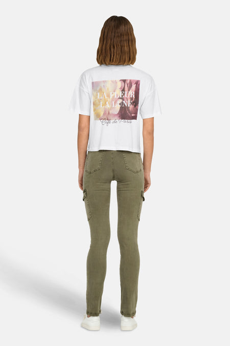 Wit T-shirt van JDY met bloemenprint en "Café de Paris" opschrift op de rug, gedragen met een olijfgroene cargobroek.
