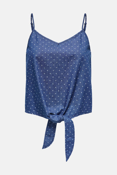 Chemisier sans manches bleu denim de ONLY, avec motif à pois blancs et nœud décoratif sur le devant.
