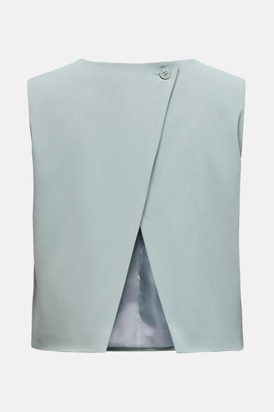 Blouse bleue sans manches de ONLY, avec une fermeture asymétrique à bouton unique.
