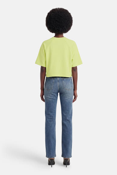 T-shirt à manches courtes vert de ONLY, coupe ample et courte, vu de dos avec un jean bleu.