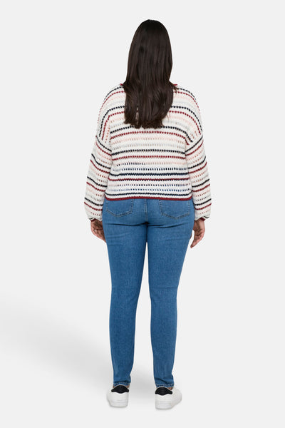 Pull à col rond multicolore de CARMAKOMA avec motif rayé porté avec un jean bleu.