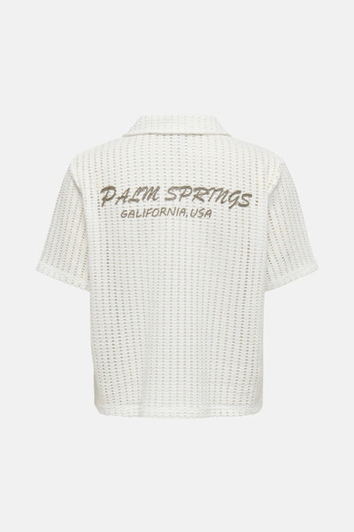 Chemise blanche à manches courtes de ONLY, motif ajouré avec inscription «Palm Springs» au dos.
