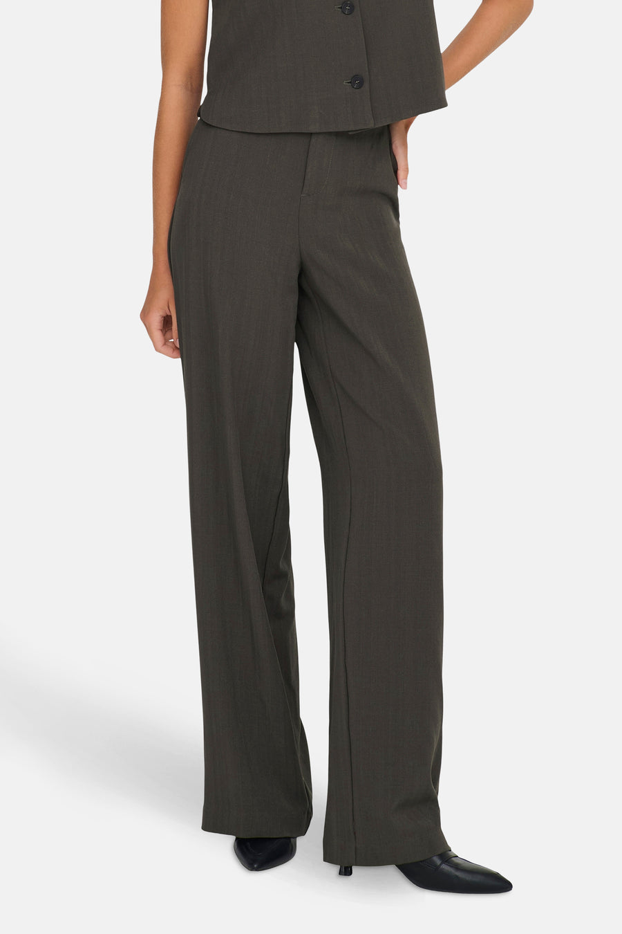 Pantalon de costume brun de ONLY, à jambes larges et coupe tailleur, porté avec des chaussures noires.