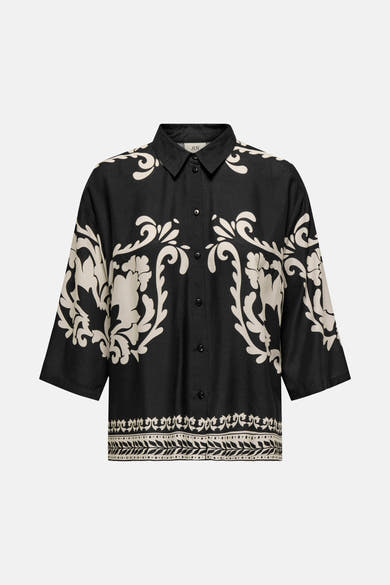 Chemisier noir à manches longues de JDY, avec motif floral beige sur fond noir et bordure décorative.