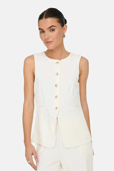 Gilet blanc de JDY avec boutons et poches plaquées, porté avec un pantalon blanc assorti.
