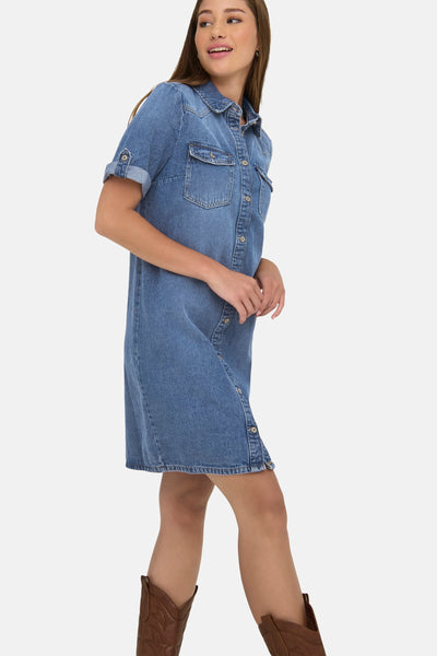 Medium blue denim robe with button front, chest pockets, and rolled sleeves, worn with brown cowboy boots, side view.