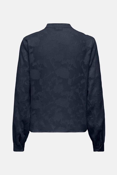 Chemise à manches longues bleue texturée de JDY, avec motif floral subtil et manches longues bouffantes.

