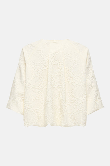 Veste courte blanc cassé de ONLY® avec motifs floraux texturés en relief, vue de dos.