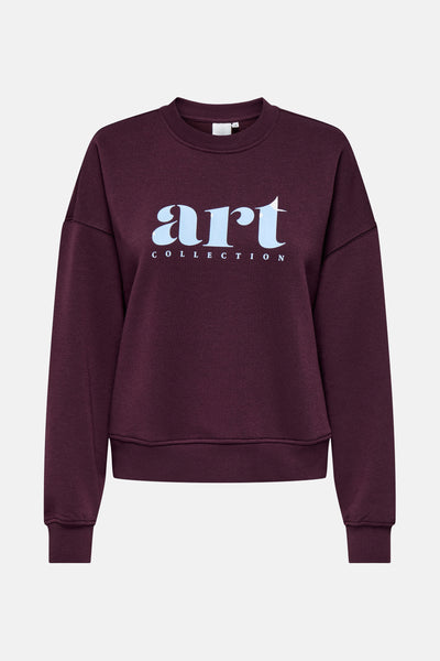 Sweat rouge de ONLY, avec l'inscription « art collection » bleu clair sur le devant.