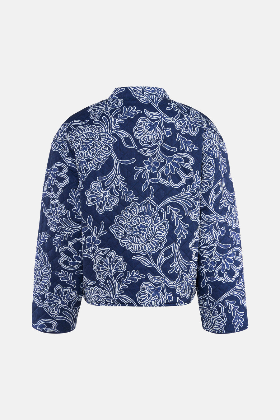 Veste courte bleue de JDY, avec motif floral blanc et matelassage losanges visible de dos.
