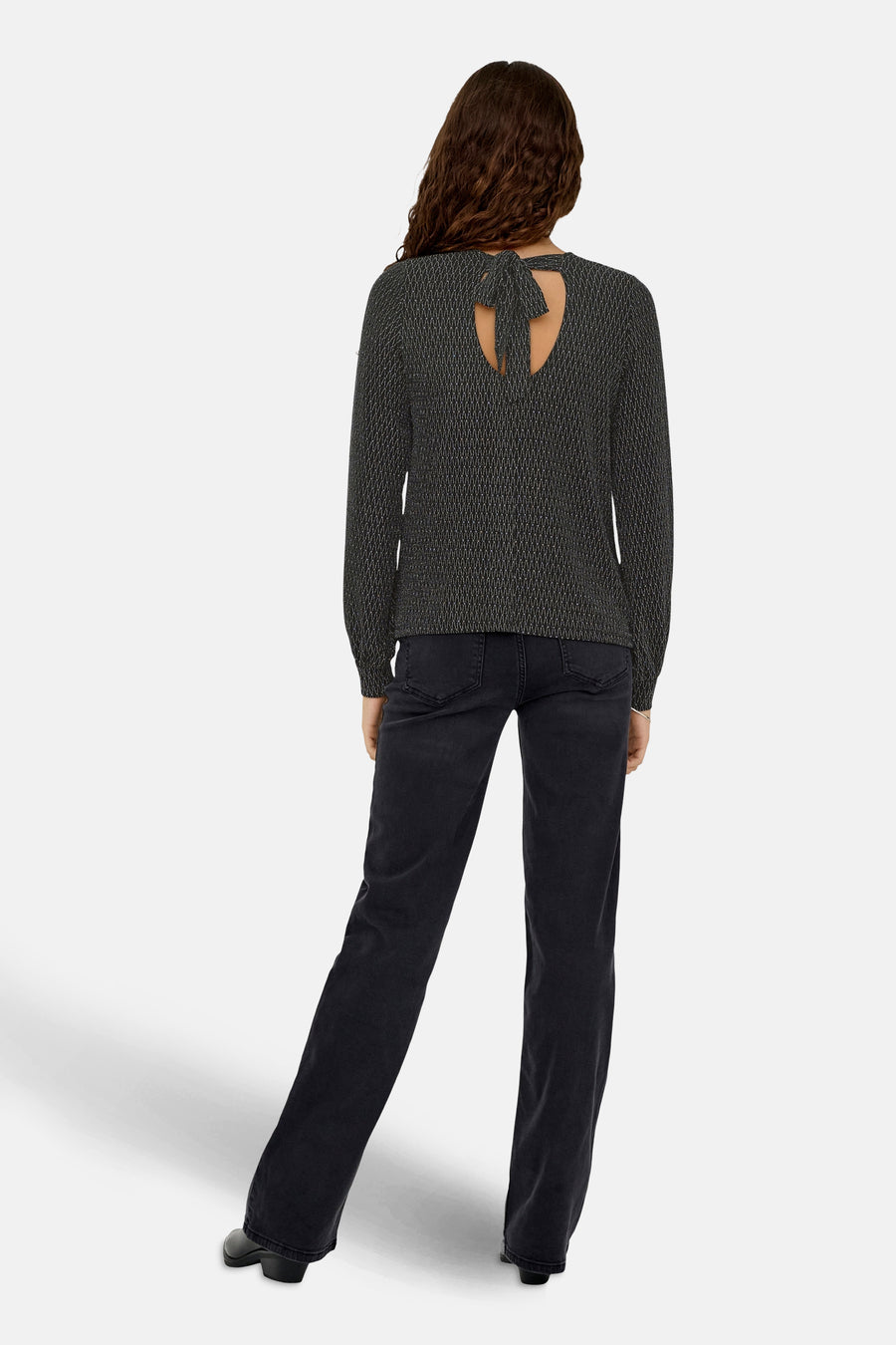 Zwart blouse met lange mouwen van ONLY®, met een decoratieve strik op de rug, gedragen met een zwarte jeans.