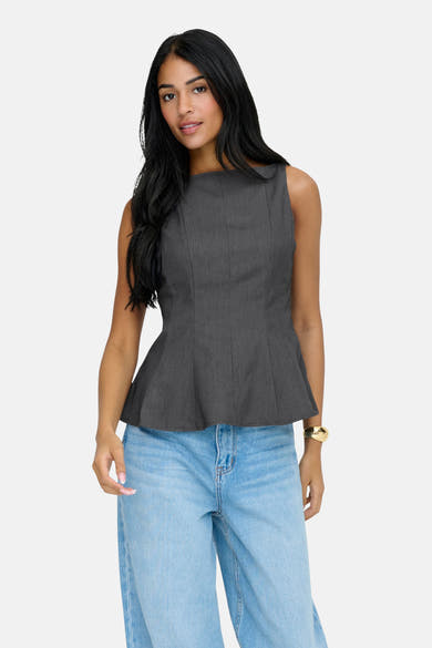 Grijs ONLY® blouse met peplum-snit, gedragen met een high-waist casual jeans en een gouden armband.