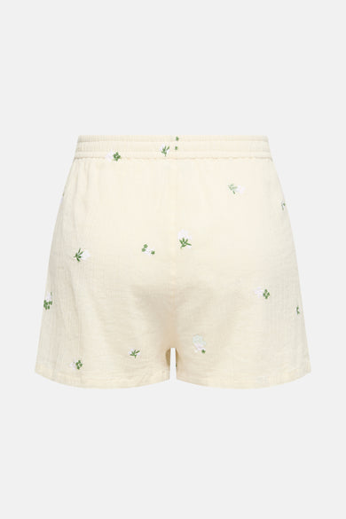 Short beige de JDY avec broderies florales blanches et vertes, taille élastique.