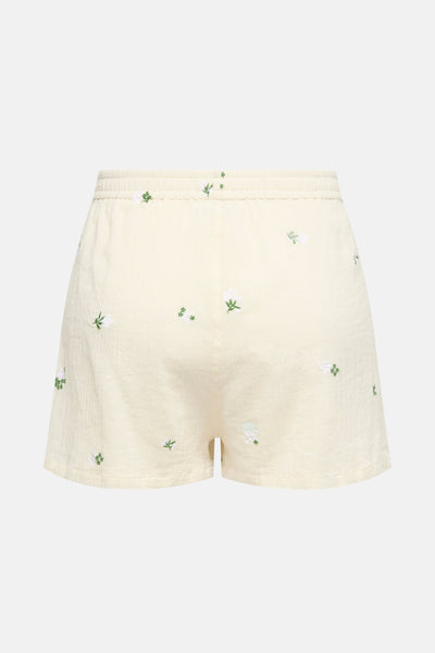 Short beige de JDY avec broderies florales blanches et vertes, taille élastique.