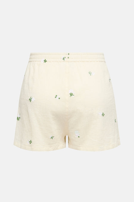 Short beige de JDY avec broderies florales blanches et vertes, taille élastique.