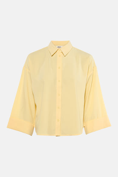 Chemisier jaune à manches longues de ONLY, coupe ample avec fermeture boutonnée centrée.