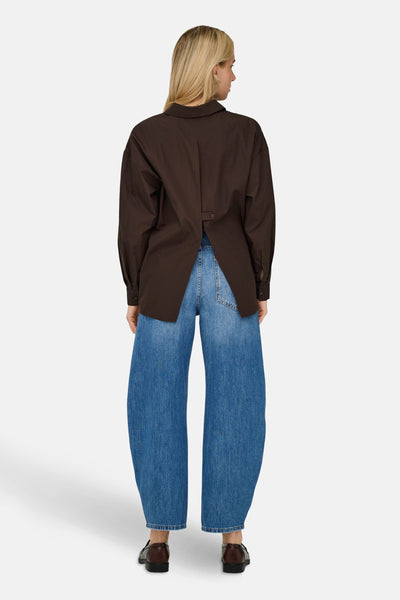 Chemisier à manches longues brun de ONLY®, avec une coupe ample et porté avec un jean large.
