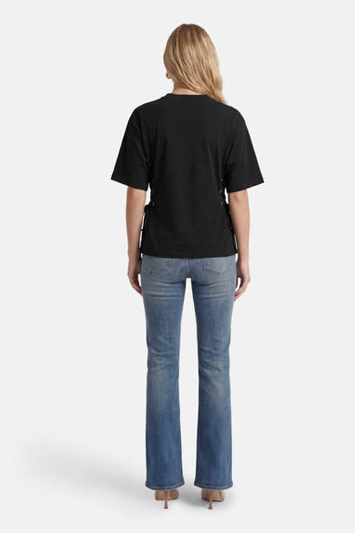 T-shirt noir à manches courtes de ONLY, avec des lacets décoratifs sur les côtés et porté avec un jean.