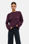 Mauve wine crewneck sweater with textured knit and relaxed fit, worn with dark trousers in front view