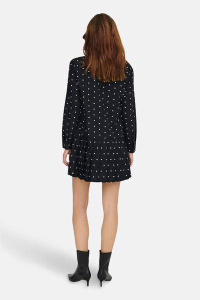 Robe noire à pois blancs de ONLY, vue de dos, portée avec des bottines noires.
