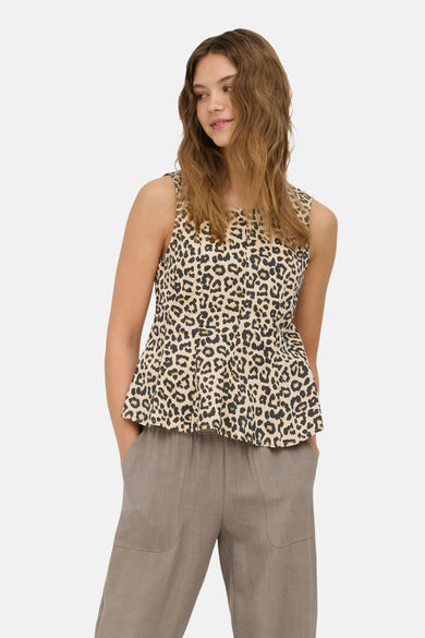 Sleeveless leopard-print blouse in pumice stone with peplum hem, worn with taupe trousers, front view.