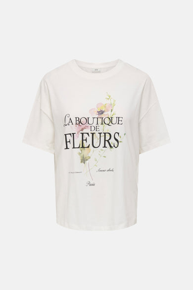 T-shirt blanc de JDY avec imprimé floral et texte français "La Boutique de Fleurs" sur le devant.