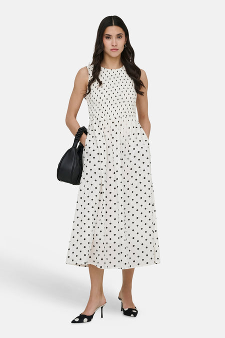 Witte jurk met zwarte stippen van JDY, met zwarte tas en bijpassende gestipte schoenen.
