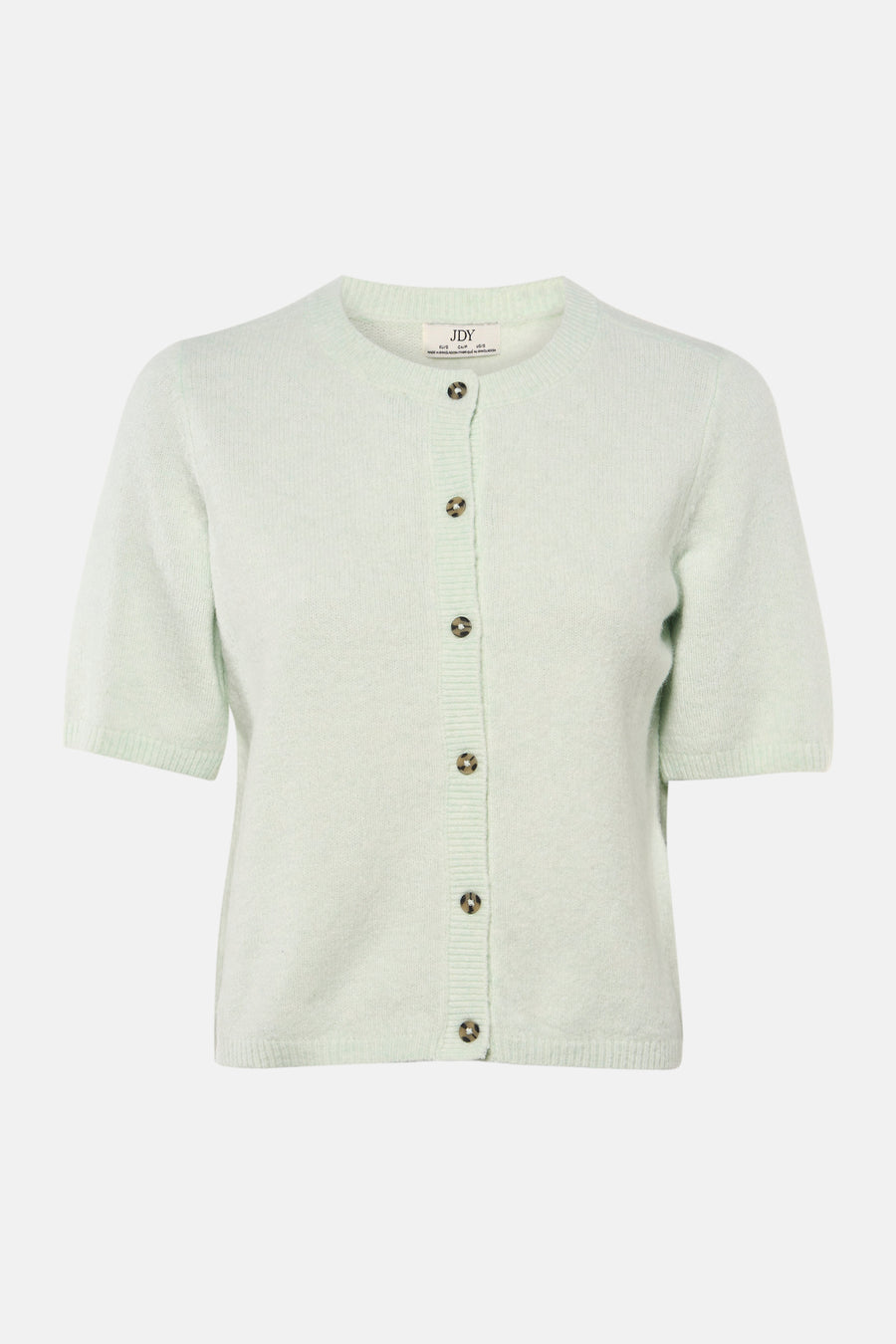 Groene JDY trui gedragen met een wijde zwarte broek en zwarte pumps met hak.