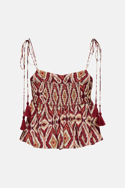 Brick red sleeveless blouse with ikat pattern and tassel straps, front view