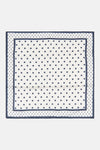 White silk foulard with navy polka dots and border, flat lay view
