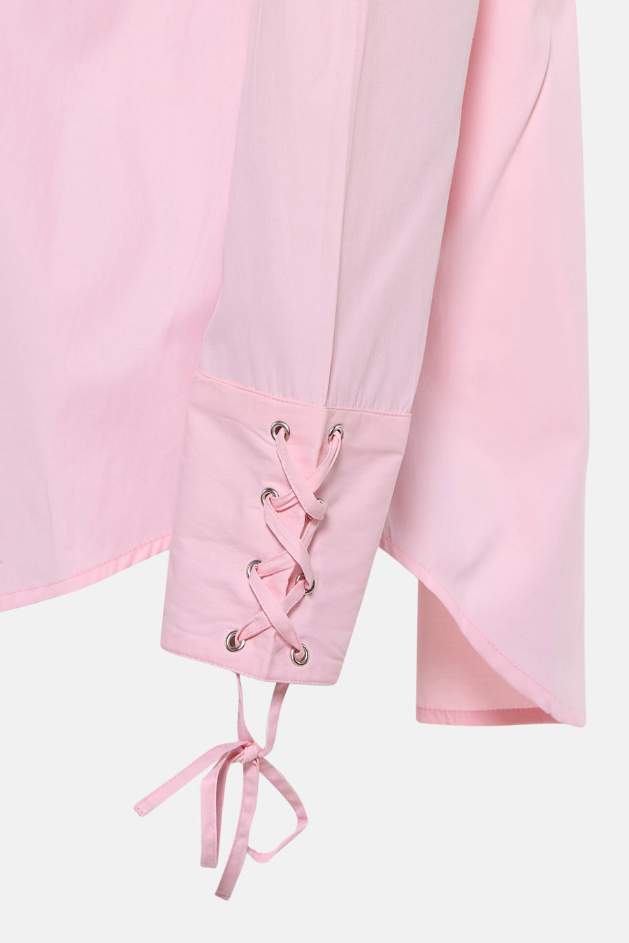 Pink long-sleeve t-shirt with lace-up cuffs and silver eyelets, close-up side view