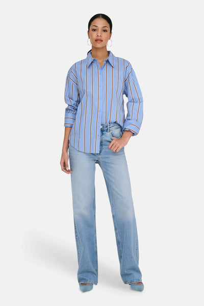 Light blue long-sleeve striped chemise with brown vertical stripes, worn with light wash jeans and silver hoop earrings, front view.