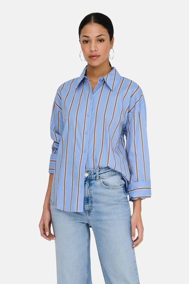Light blue long-sleeve striped chemise with brown vertical stripes, button-down front, and cuffed sleeves, worn with light wash jeans in a lifestyle front view.