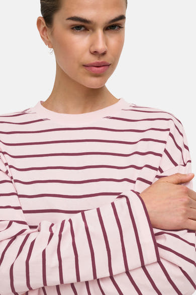 Pale lilac long-sleeve t-shirt with burgundy horizontal stripes, round neckline, and soft knit texture, shown in close-up front view on model.