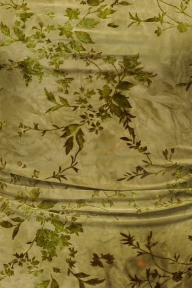 Dark olive sleeveless dress with shimmering leafy vine embroidery, close-up texture view
