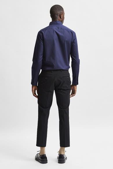 Blauw overhemd met lange mouwen van SELECTED, gedragen met een zwarte broek en nette schoenen.