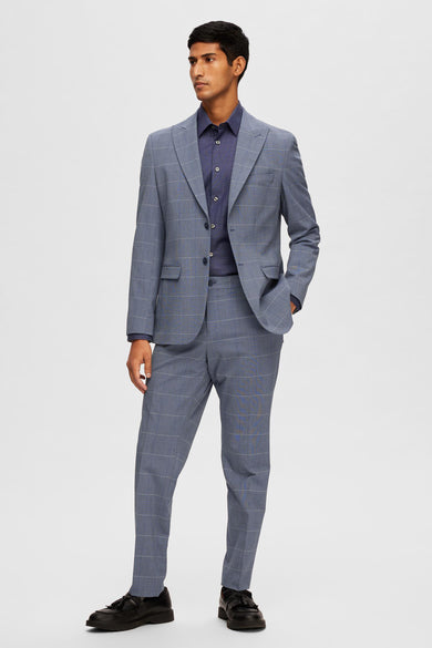 Blazer bleu de SELECTED, à carreaux discrets, porté sur une chemise boutonnée bleu foncé.