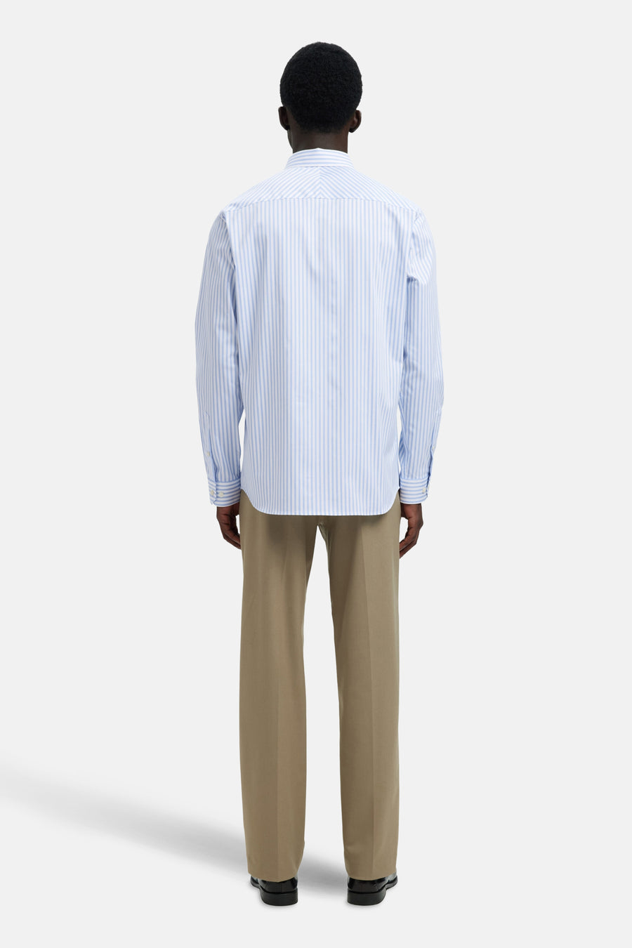 Chemise à manches longues bleue à rayures, de SELECTED, portée avec un pantalon beige.