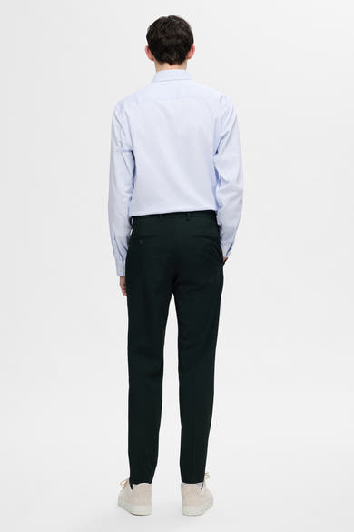 Chemise à manches longues blanche rayée de SELECTED, portée avec un pantalon foncé et des chaussures de sport beiges, vue de dos.
