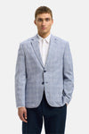 Blauwe blazer van SELECTED met ruitpatroon gedragen over een wit overhemd en een marineblauwe broek.