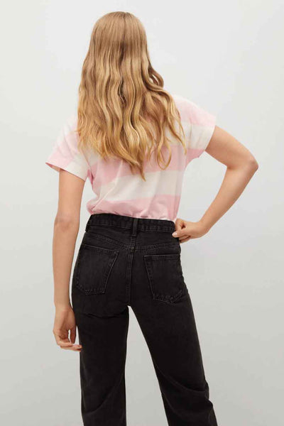 Rose and white striped short-sleeve t-shirt from back view, worn with black jeans, wavy blonde hair visible