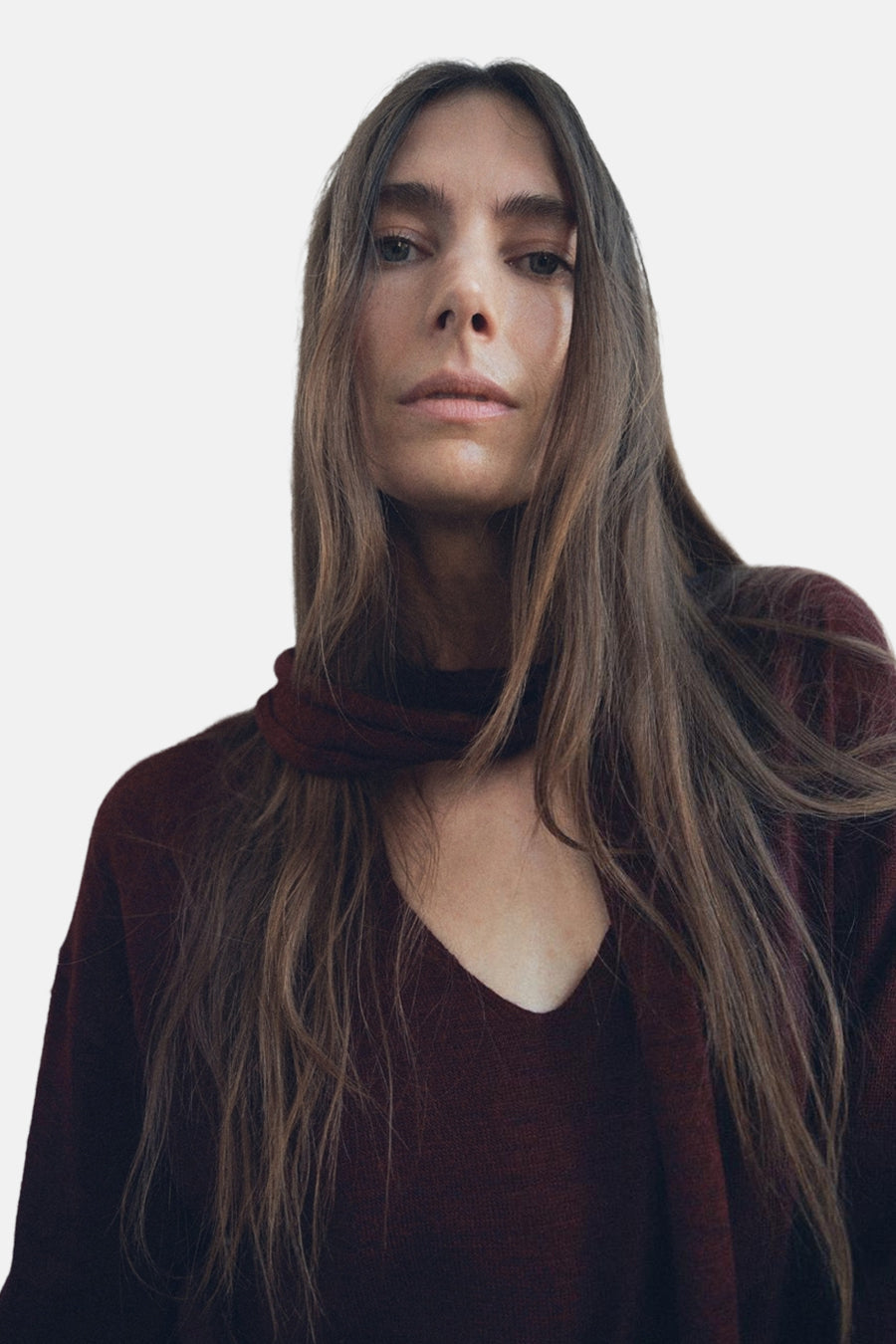 Pull à col rond bordeaux de MANGO, porté avec un foulard assorti autour du cou.