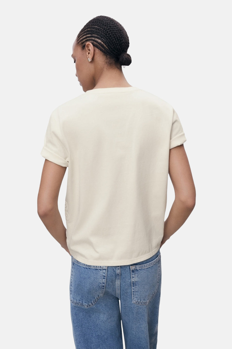 T-shirt beige à manches courtes de MANGO, porté avec un jean taille haute bleu, vue de dos.